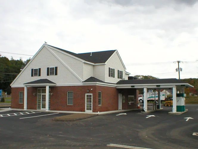 Brick and clapboard bank branch with a drive-through canopy