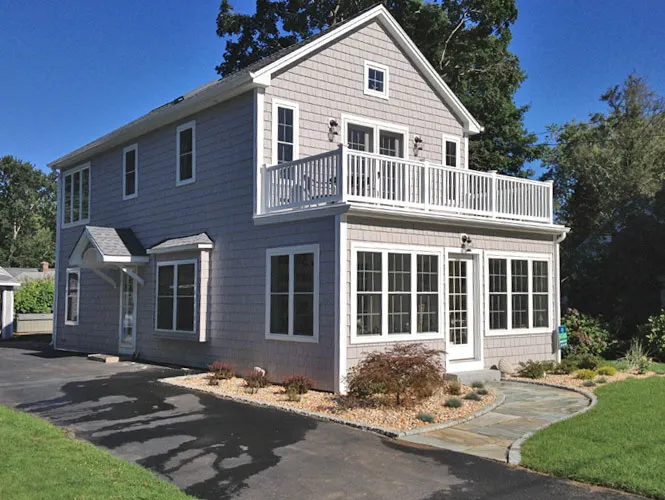 Shingled custom home with a second-storey deck, built in Connecticut