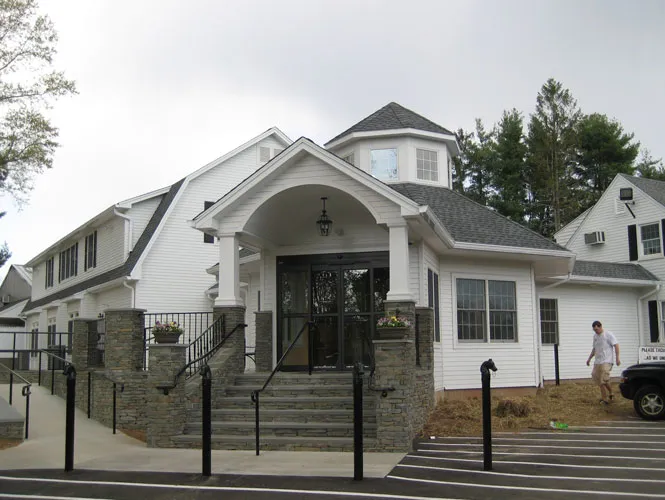 Commercial entrance with stone piers, columns and a covered portico