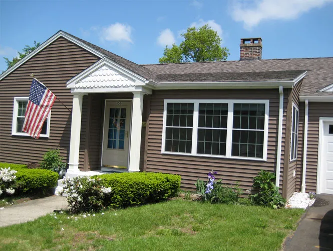 Connecticut home with new siding, a bay window and a front portico