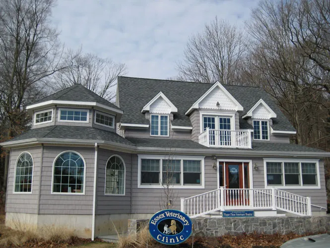 Shingled veterinary clinic with dormers, arched windows and a turret